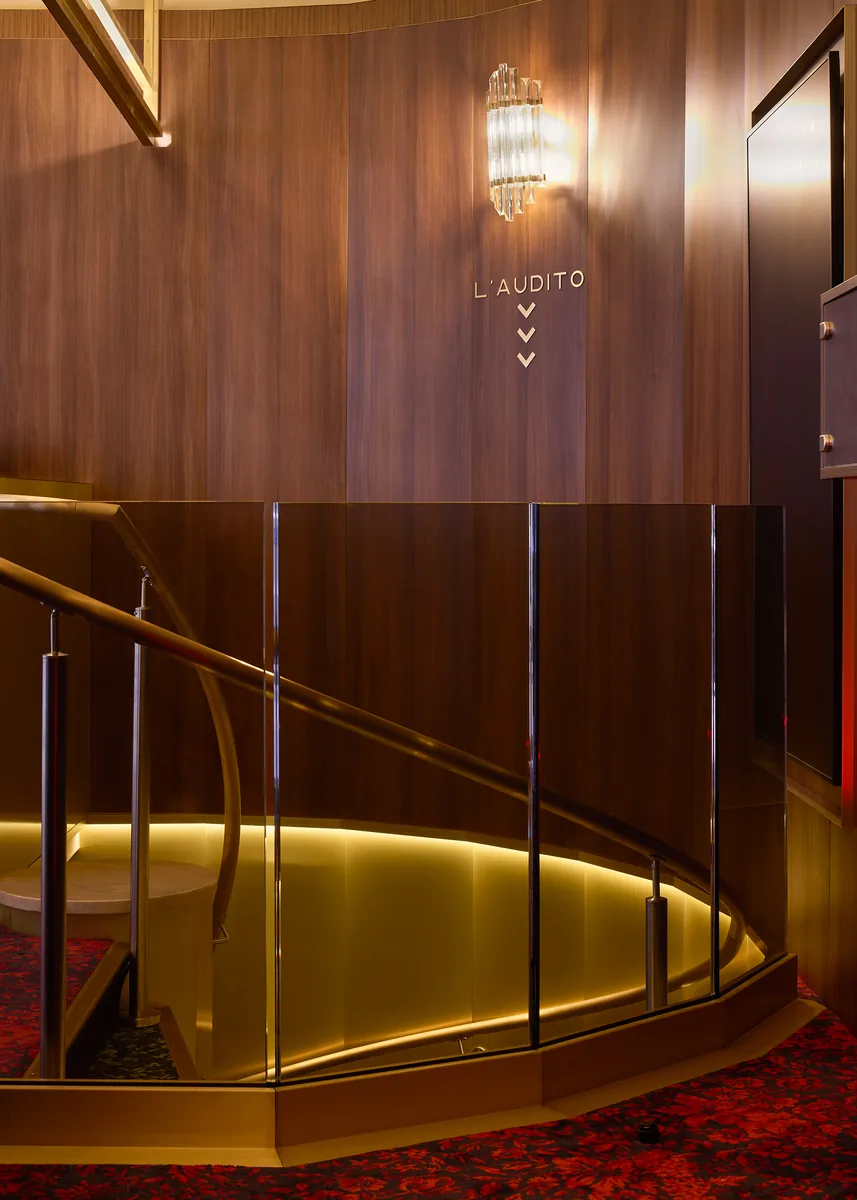 Cinema foyer with brass and mahogany stair, bespoke signage for the L'Audito auditorium.