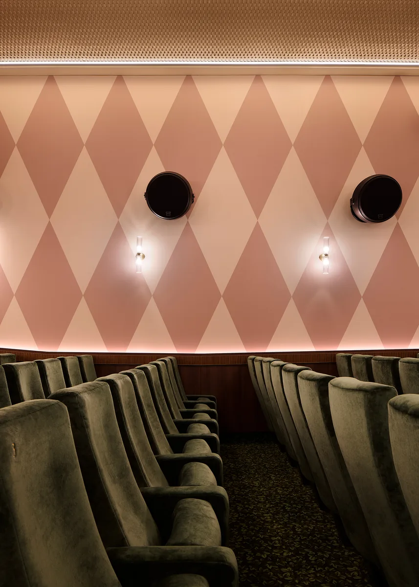 Acoustic treatment and speakers in L'Audito, with fluted glass sconces and a mahogany dado.