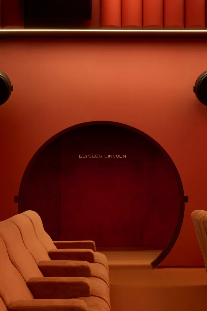 Le Club, a private-hire auditorium with a velvet arch, engraved signature, terracotta seats and round speakers.