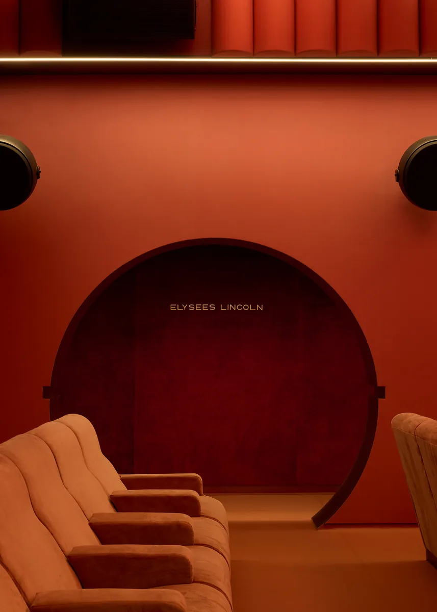 Le Club, a private-hire auditorium with a velvet arch, engraved signature, terracotta seats and round speakers.