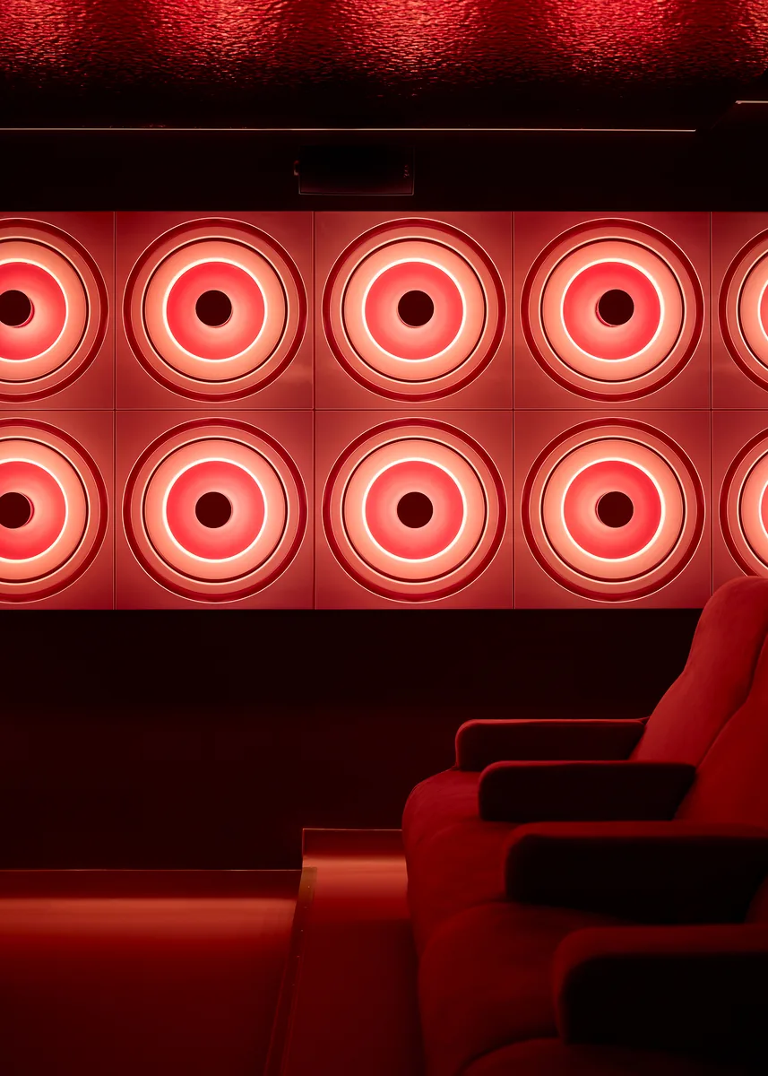 Backlit acoustic wall, a nod to Verner Panton, with bespoke backlit discs.